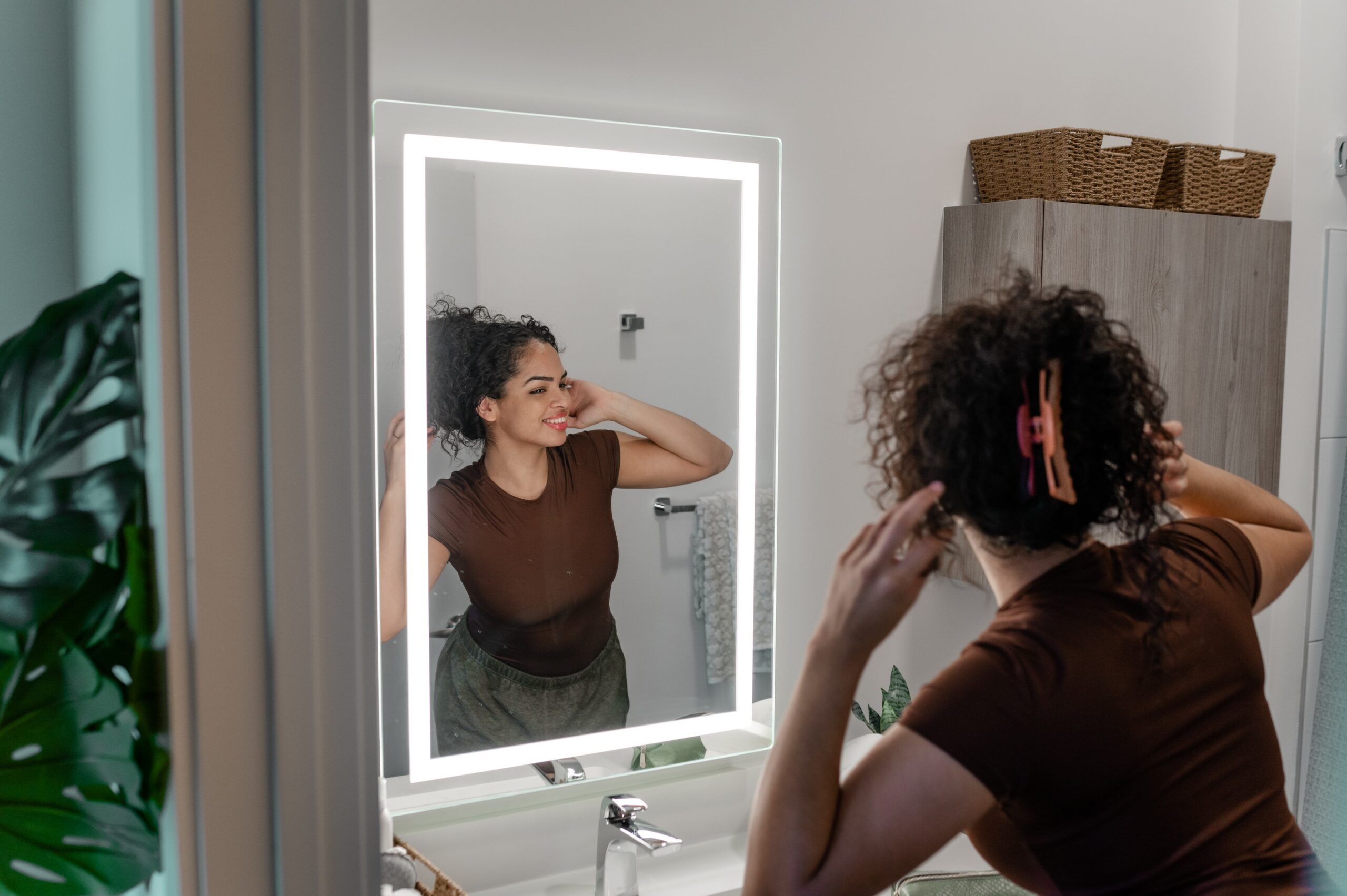 resident using led vanity mirror bathroom scaled