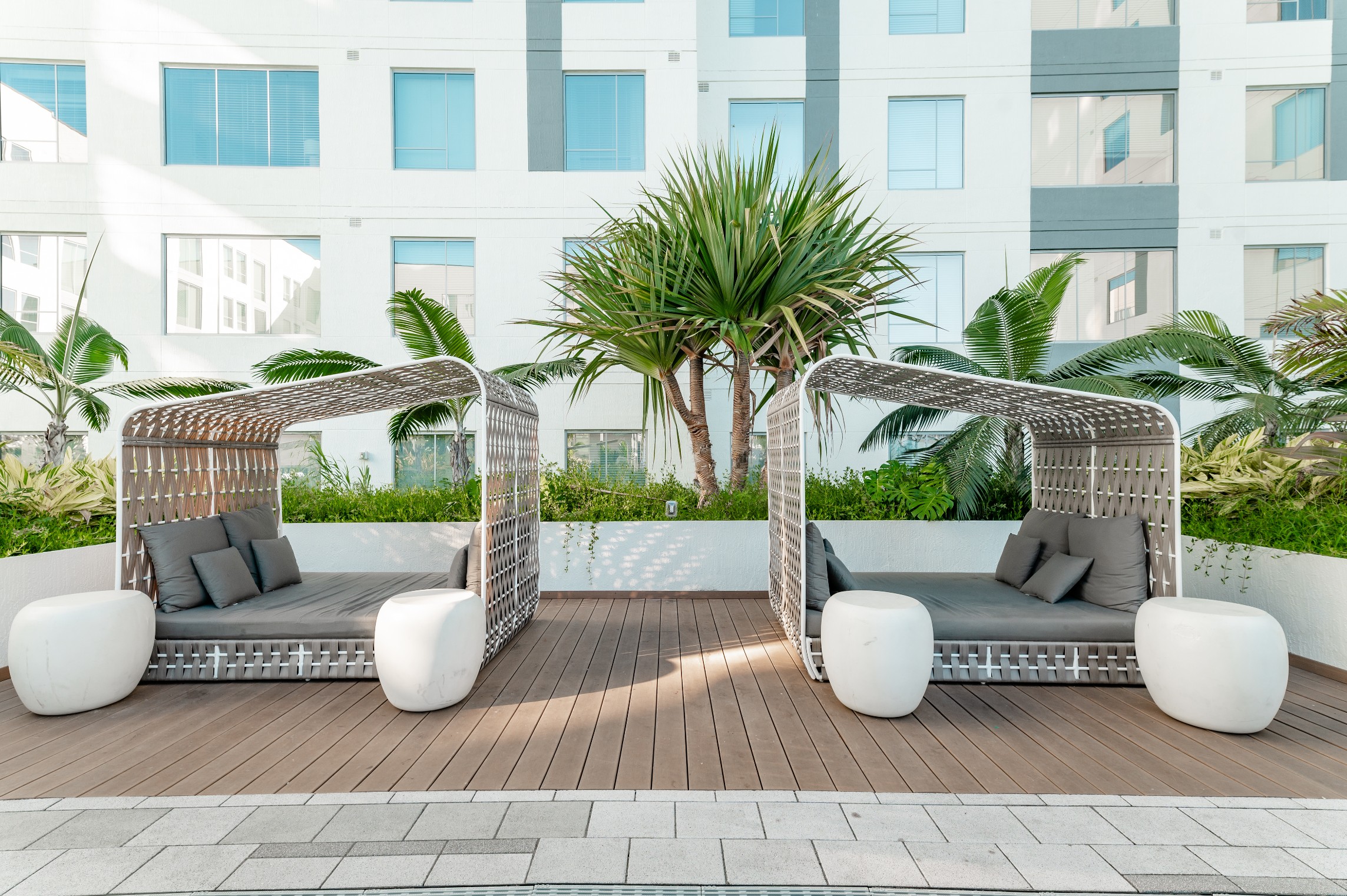resort pool deck covered daybeds cabanas