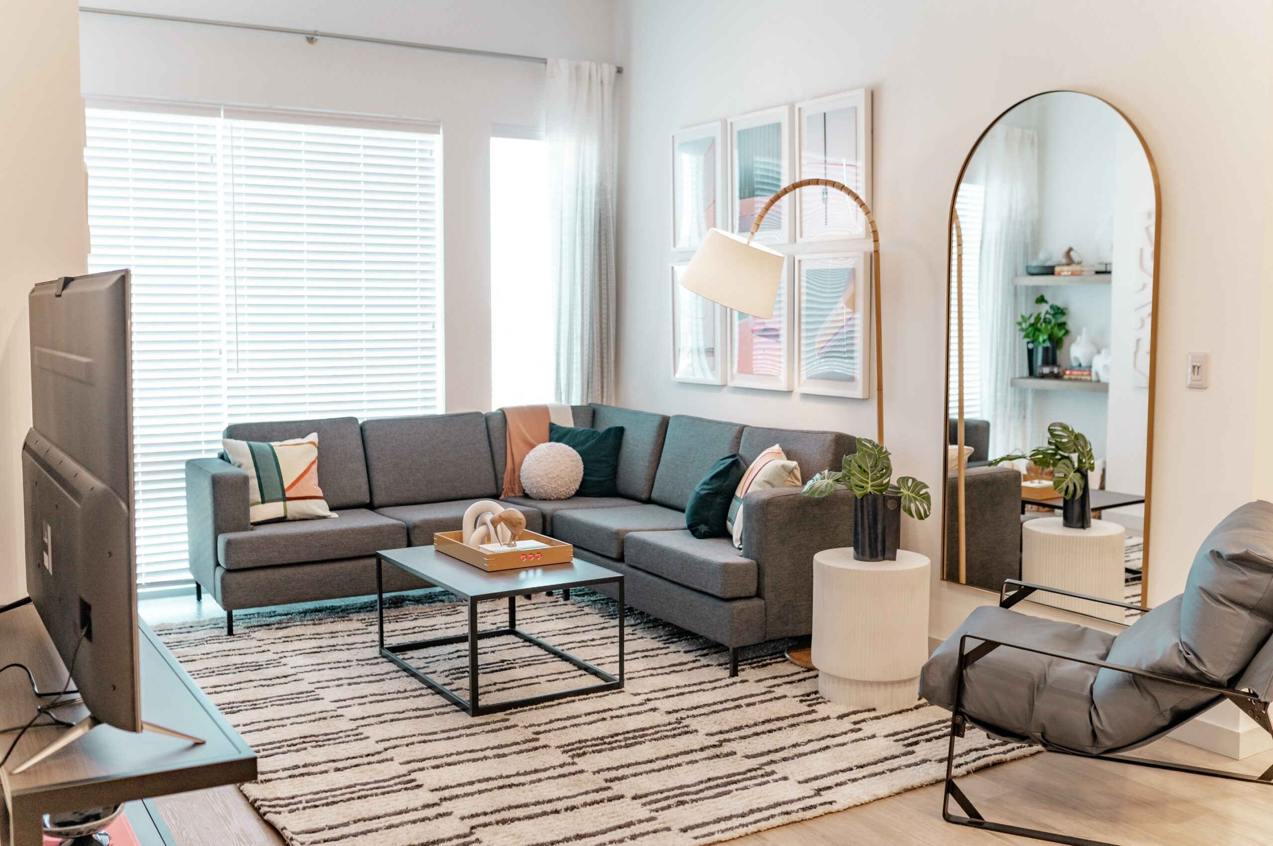 spacious living room sectional sofa large mirror scaled